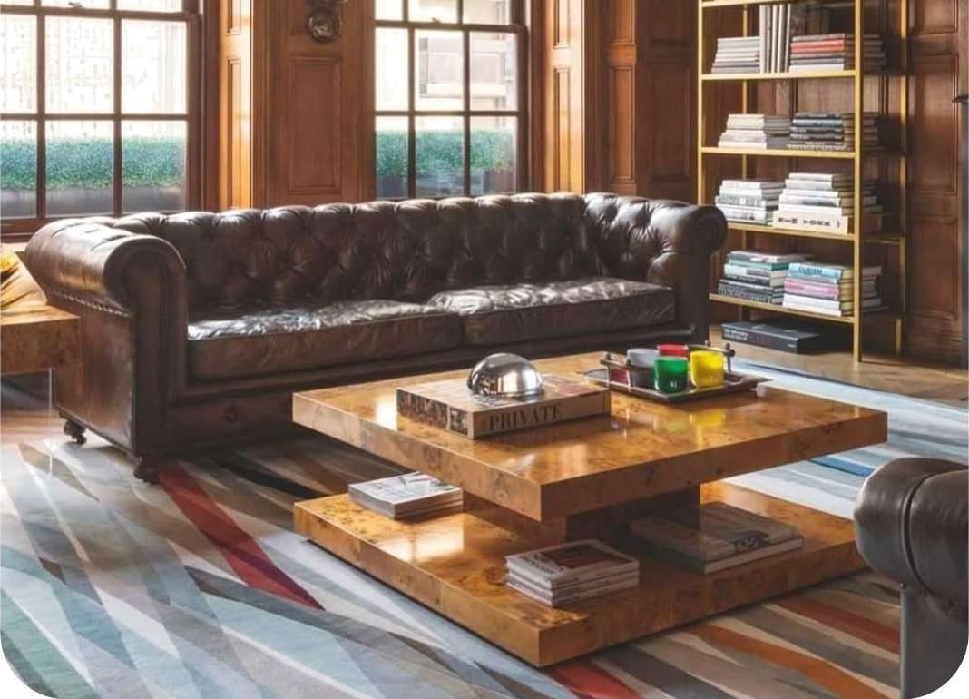 A striped flatweave rug laid in a panelled library room